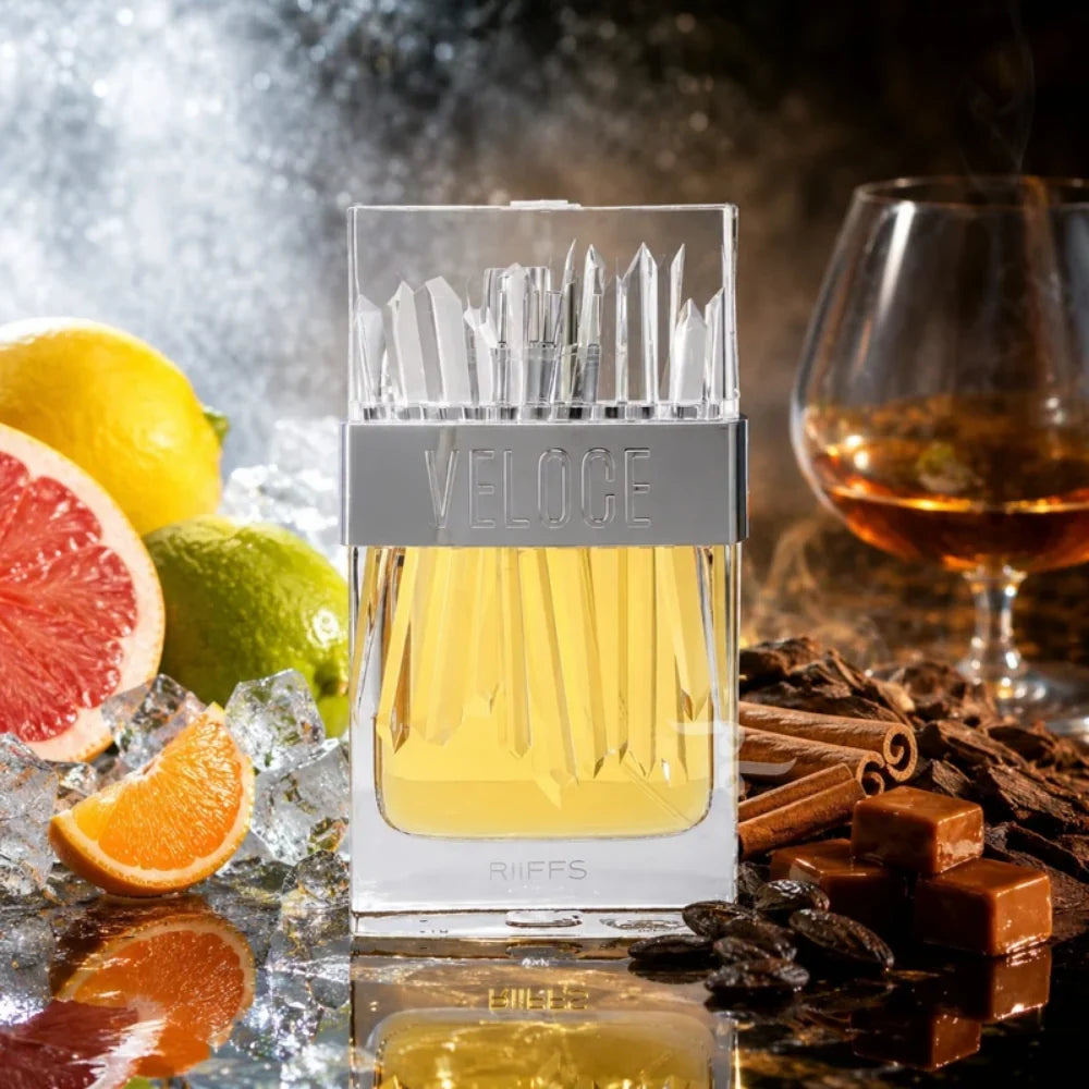 Riiffs Veloce 100ml perfume bottle with a crystal-textured cap, surrounded by fresh citrus, ice, and amber-toned ingredients.